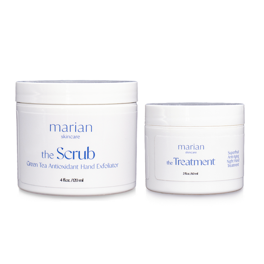 marian skincare the Evening Routine, the Scrub and the Treatment; two white jars sitting side by side, with white labels and periwinkle and black lettering. The jar on the left is slightly larger and reads " marian skincare, the Scrub, Green Tea Antioxidant Hand Exfoliator, 4 fluid ounces, 120 milliliters". The smaller jar on the right reads "marian skincare, the Treatment, Superfruit Anti-Aging Night Hand Treatment, 2 fluid ounces, 60 milliliters".