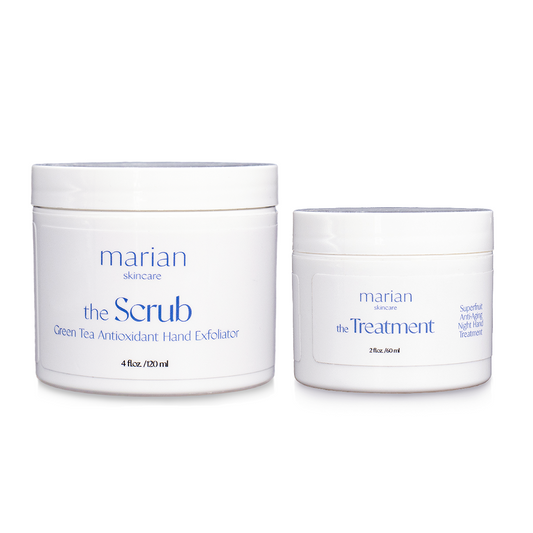 marian skincare the Evening Routine, the Scrub and the Treatment; two white jars sitting side by side, with white labels and periwinkle and black lettering. The jar on the left is slightly larger and reads " marian skincare, the Scrub, Green Tea Antioxidant Hand Exfoliator, 4 fluid ounces, 120 milliliters". The smaller jar on the right reads "marian skincare, the Treatment, Superfruit Anti-Aging Night Hand Treatment, 2 fluid ounces, 60 milliliters". 