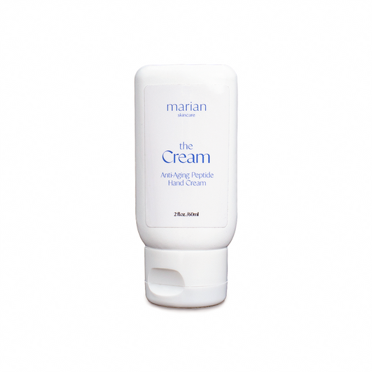 marian skincare the Cream, Anti-Aging Peptide Hand Cream; a small white bottle of hand cream, with a white label and periwinkle lettering that reads "marian skincare, the Cream, Anti-Aging, Peptide Hand Cream, 2 fluid ounces, 60 milliliters.". 